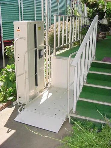 A residential porch lift platform at the top of its travel